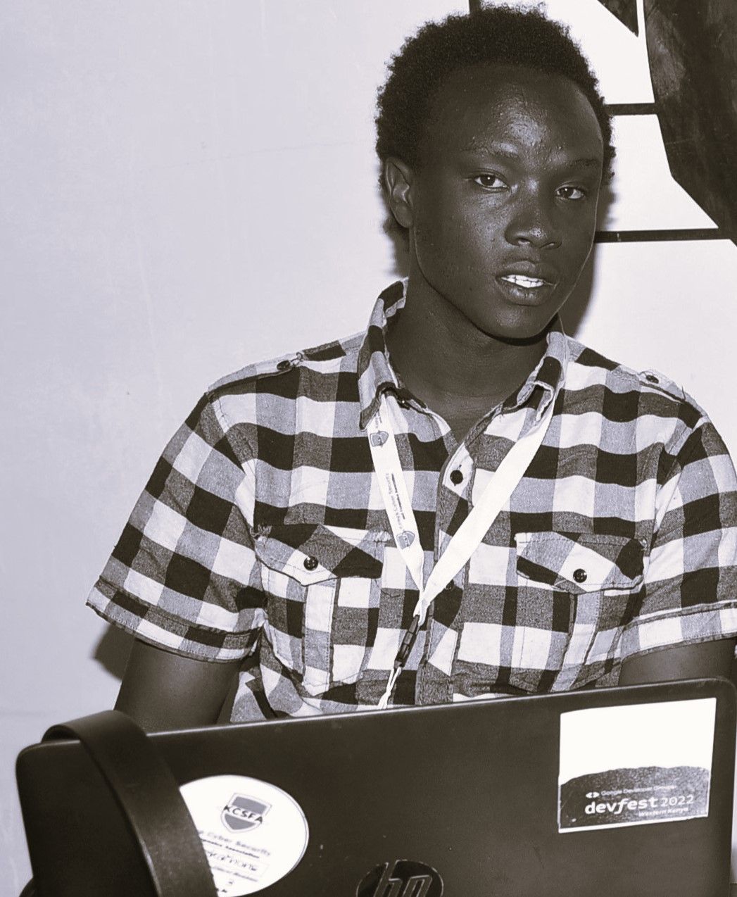 Silas Moracha at Google DevFest with his laptop